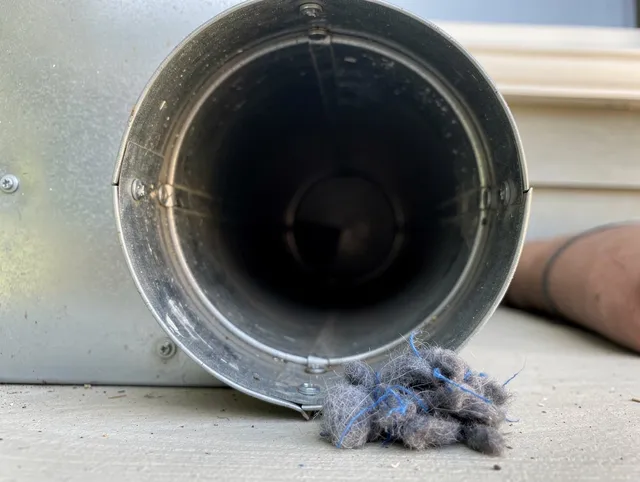 Paramount Dryer Vent Cleaning technician using specialized equipment to clear severe dryer vent blockage in Paramount